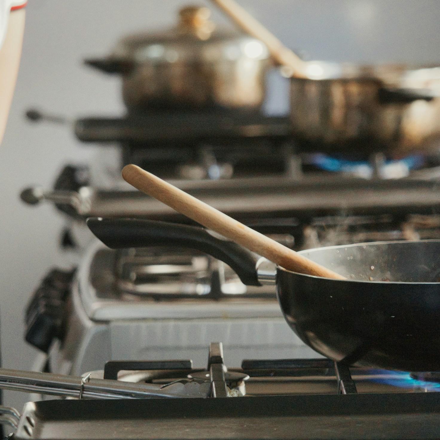 Diverse group of community members sharing a meal together, showcasing the social bonds formed through collaborative cooking